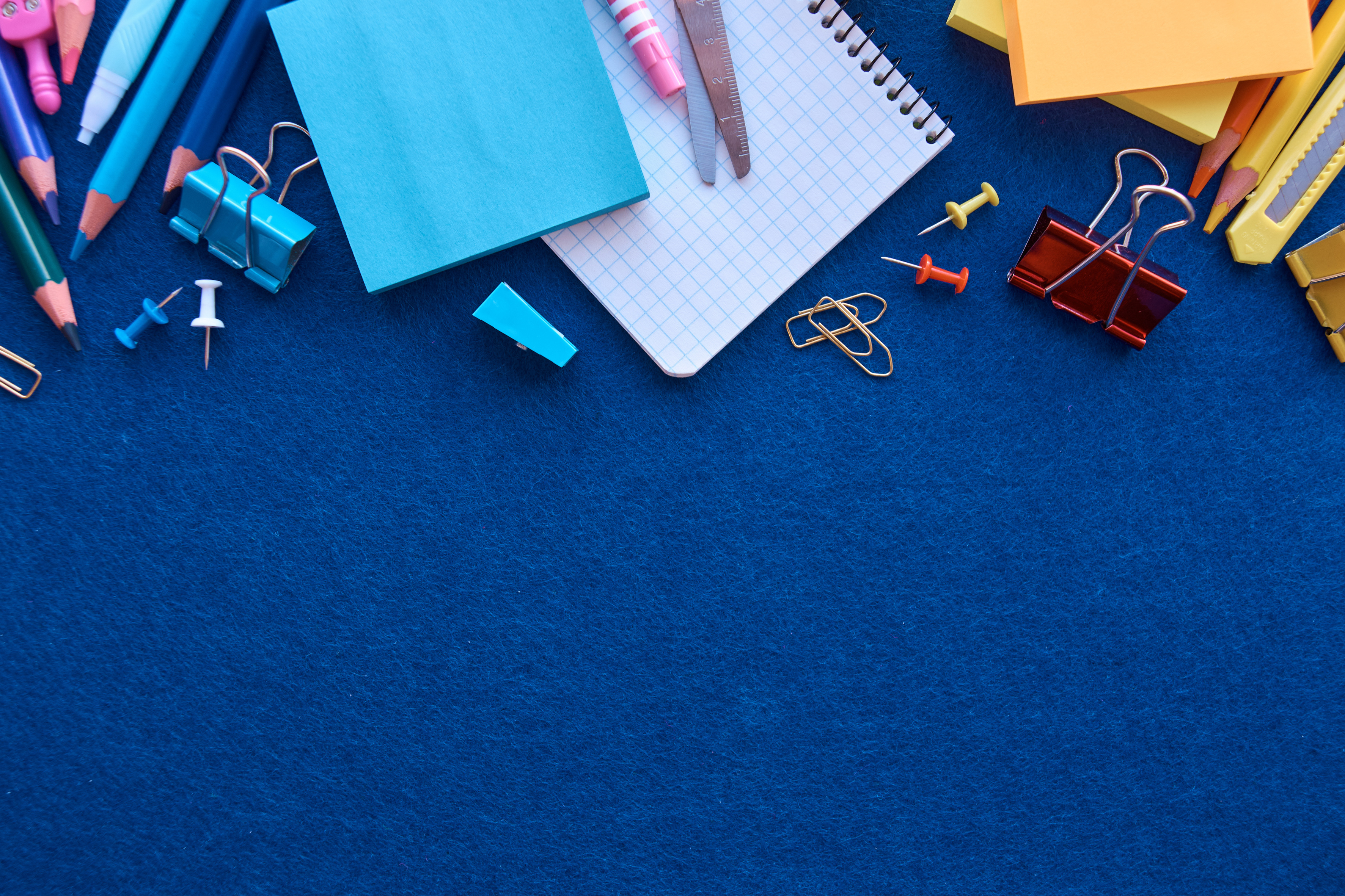 Stationery set on blue background. School supplies top view for advertising and promotional items. Back to school concept